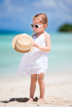 Adorable little girl on tropical beach vacationの写真素材