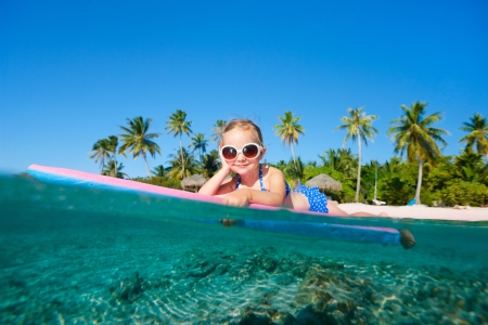 Adorable little girl on tropical vacation swimmingの写真素材