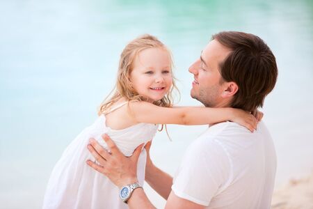 Happy father and his sweet little daughter outdoor on summer day