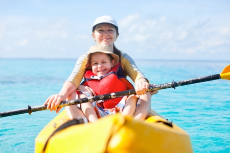 Mother and son kayaking at tropical oceanの写真素材