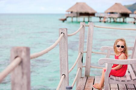 Little girl at terrace of over water bungalow
