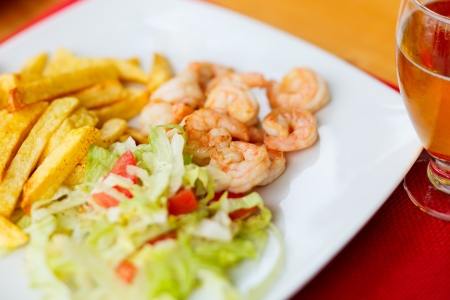 Close up of shrimps, french fries and green saladの写真素材