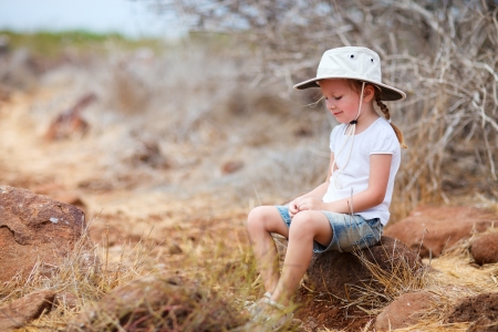 Little girl having a break at hike on Galapagos North Seymour islandの写真素材