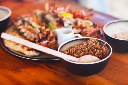 Bowl of rice and seafood platter served for lunchの写真素材