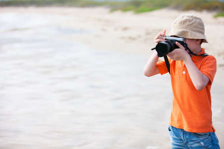 Portrait of little boy photographing outdoorsの写真素材