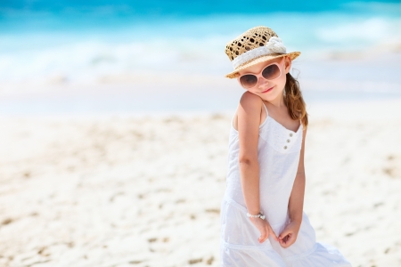 Adorable little girl at tropical white sand beachの写真素材