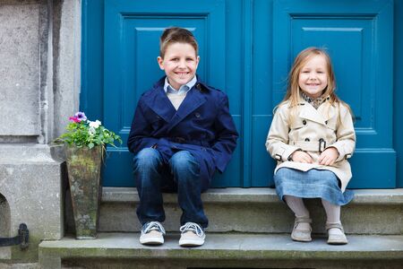 Brother and sister outdoors in city on beautiful spring day