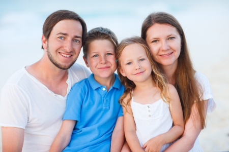 Happy beautiful family on a tropical beach vacationの写真素材