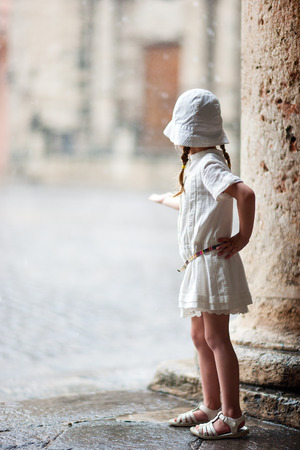 Portrait of adorable little girl outdoors on a street of old Havanaの写真素材