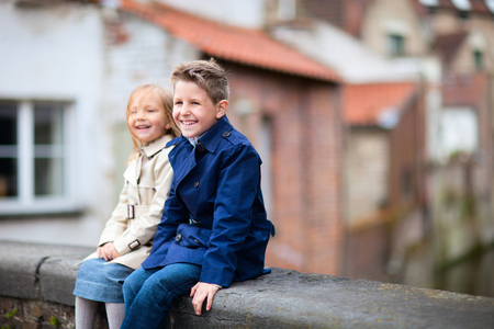 Brother and sister outdoors in city on beautiful spring dayの写真素材