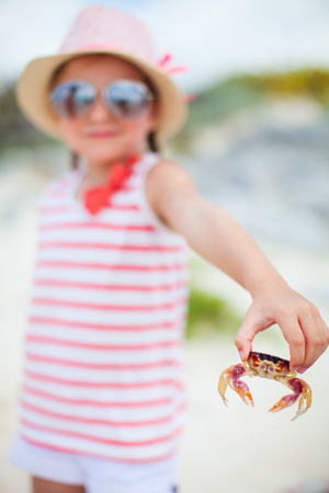 Close up of little girl holding a crabの写真素材