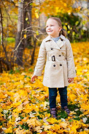 Adorable little girl outdoors at beautiful autumn dayの写真素材