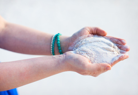 Close up of woman hands holding pink sand of Bahamasの写真素材