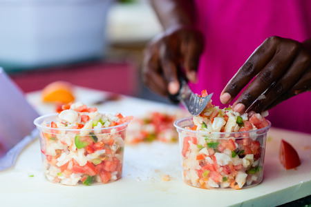 Close up of Bahamian woman making traditional conch saladの写真素材