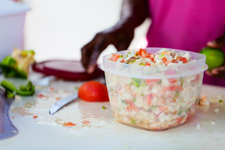 Close up of Bahamian woman making traditional conch saladの写真素材
