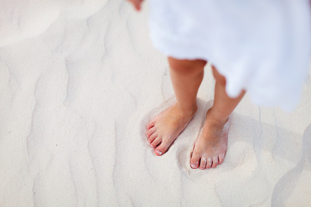 Close up of a little girl on a tropical sandy beachの写真素材