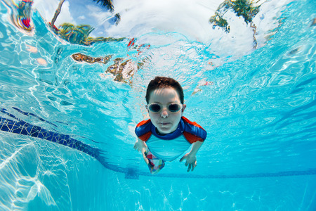 Portrait of a cute little boy swimming underwaterの写真素材