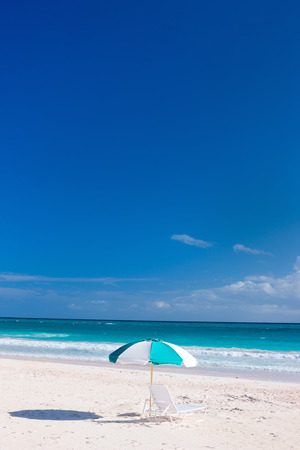 Chairs and umbrella on a beautiful Caribbean beachの写真素材