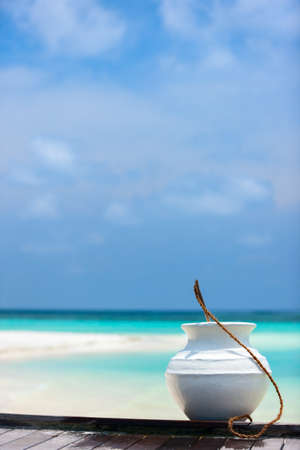 Maldives details: white ceramic jar with water to wash out sand の写真素材