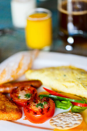 Delicious breakfast with omelet and vegetablesの写真素材