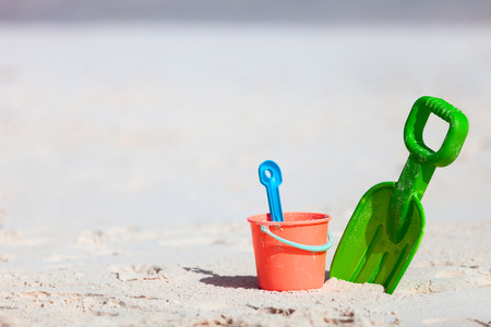 Colorful plastic beach toys at tropical Caribbean beachの写真素材