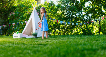 Adorable little girl having fun playing outdoors on summer dayの写真素材