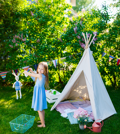 Adorable little girl having fun playing outdoors on summer dayの写真素材