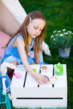 Adorable little girl having fun playing outdoors on summer dayの写真素材