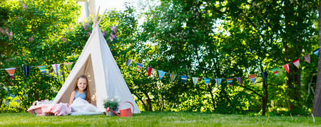 Adorable little girl having fun playing outdoors on summer dayの写真素材