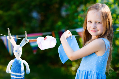 Adorable little girl having fun playing outdoors on summer dayの写真素材