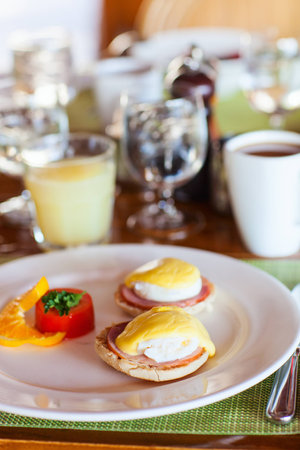 Delicious breakfast with poached eggs and coffeeの写真素材