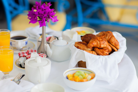 Selection of freshly baked pastry and fruit salad served for breakfastの写真素材