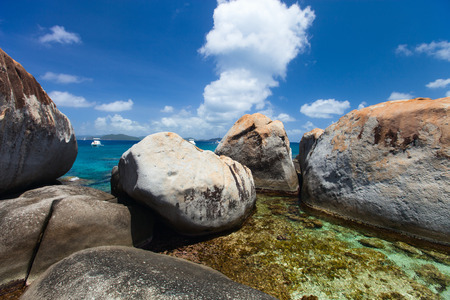 Stunning beach with unique huge granite boulders, turquoise ocean water and blue sky at Virgin Gorda, British Virgin Islands in Caribbeanの写真素材