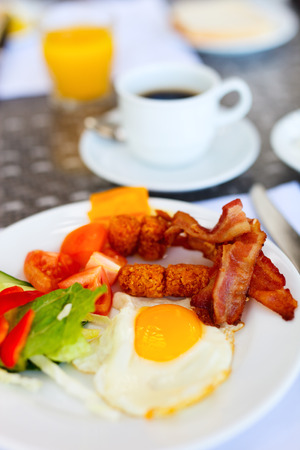 Delicious breakfast with fried eggs, bacon and vegetablesの写真素材