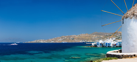 White greek windmill overlooking traditional village on Mykonos Island, Greece, Europeの写真素材
