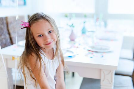 Adorable little girl with princess crown at kids birthday partyの写真素材