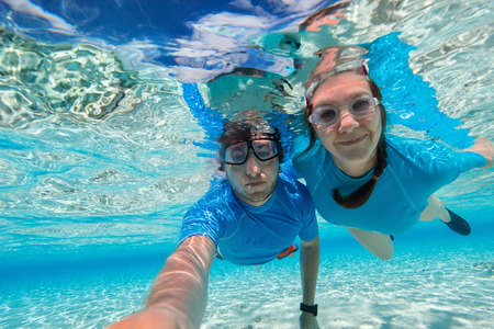 Underwater photo of a couple snorkeling in oceanの写真素材