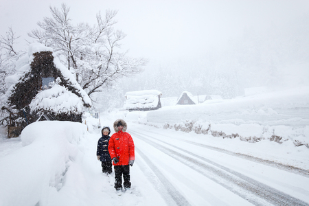 Kids at historic Japanese village Shirakawa-go at winter, travel landmark of Japanの写真素材
