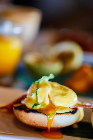 Delicious breakfast with eggs Benedict and juiceの写真素材