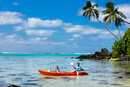 Father and daughter kayaking at tropical oceanの写真素材