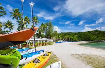 Beautiful tropical beach with palm trees, white sand, turquoise ocean water and blue sky at exotic islandの写真素材