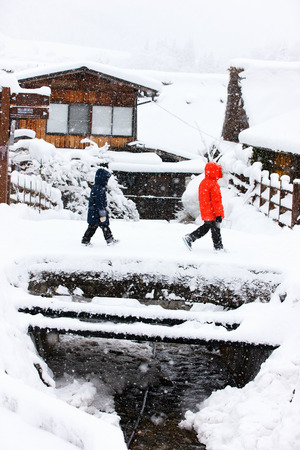 Kids at historic Japanese village Shirakawa-go at winter, travel landmark of Japanの写真素材