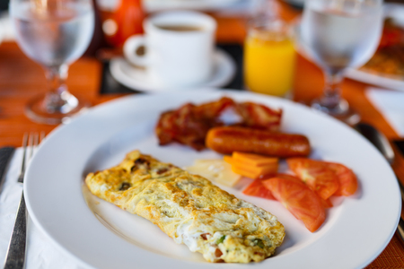 Delicious breakfast with eggs Benedict, bacon, orange juice and coffeeの写真素材