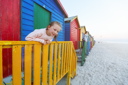 Kids playing at famous colorful huts of Muizenberg beach near Cape Town in South Africaの写真素材