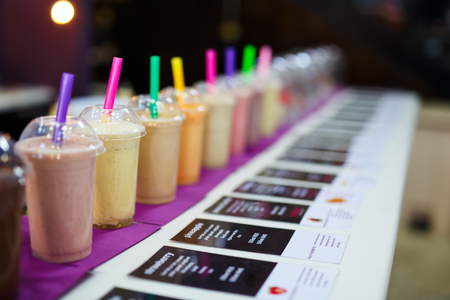 Fresh healthy smoothies with straws for saleの写真素材
