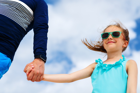 Adorable little girl holding her father handの写真素材