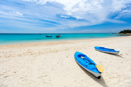 Colorful blue kayak at tropical white sand beachの写真素材
