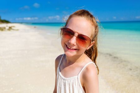 Adorable little girl at beach during summer vacationの写真素材