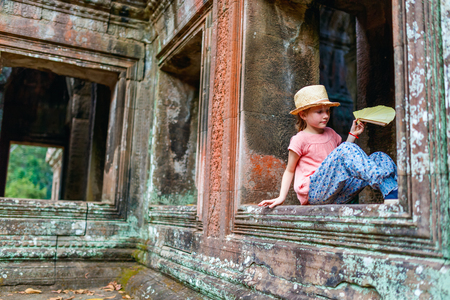 Little girl in ancient Angkor Wat temple in Siem Reap, Cambodiaの写真素材