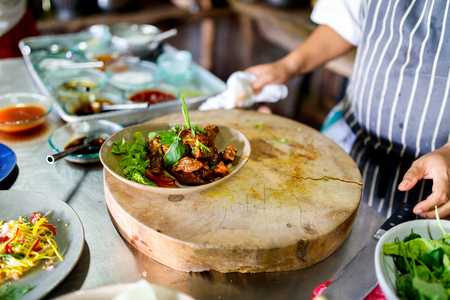 Chef making traditional cambodian meat dish at cooking classの写真素材
